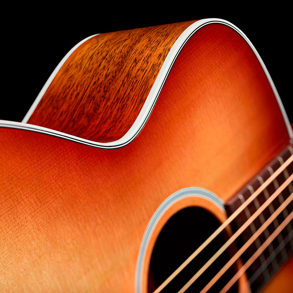 Close-up of M-40 Standard Pacific Sunset Burst showcasing solid Sitka Spruce top and White ABS body binding thumb