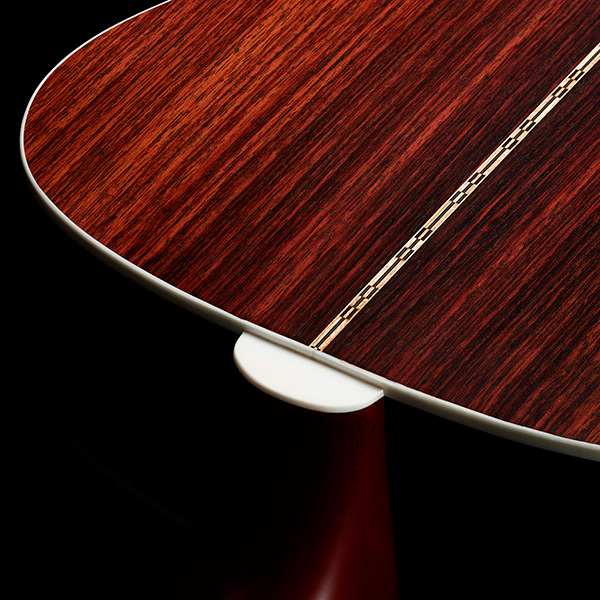 Close-up of M-50 Standard Natural heel showcasing solid Indian rosewood back and sides thumb