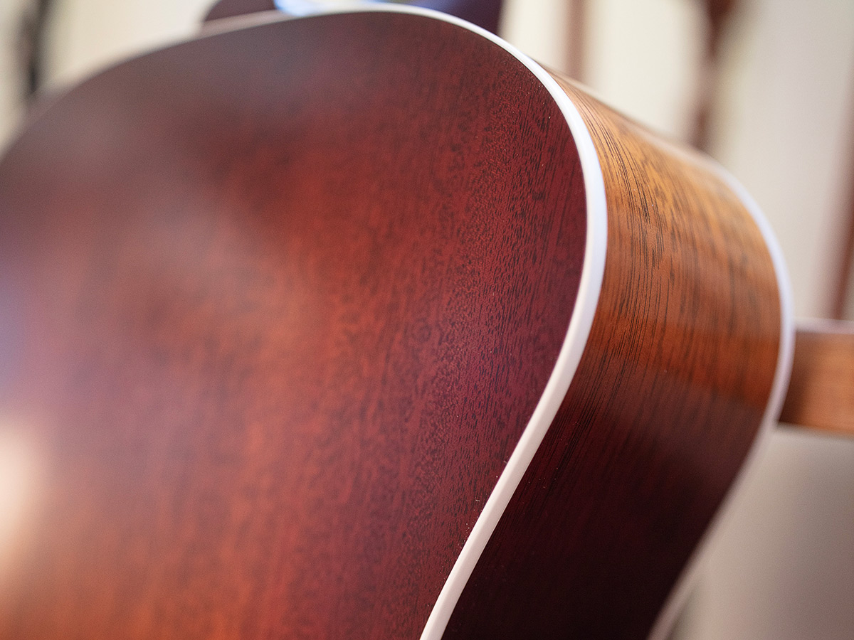 Close-up of F-40 Standard Pacific Sunset burst guitar shoulder highlighting solid African mahogany back and sides
