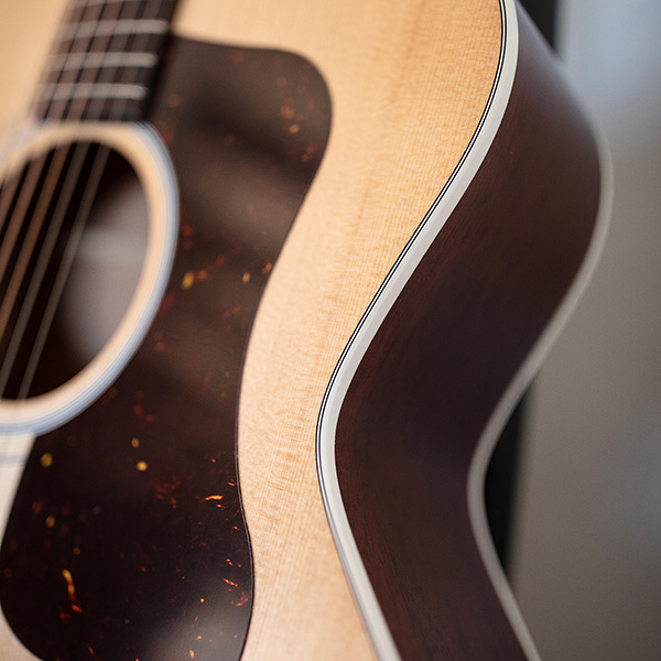 Close-up of F-40 Standard Natural pickguard thumb