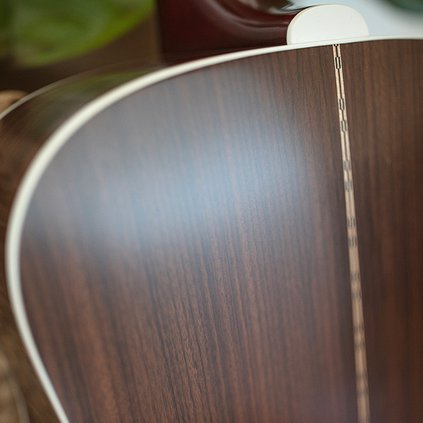 Close-up of the back of the D-50 Standard Antique Burst showcasing the solid Indian rosewood back thumb