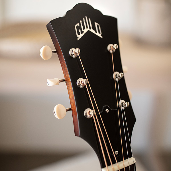 Close-up of D-40 Standard Pacific Sunset Burst headstock with Guild Peak logo thumb