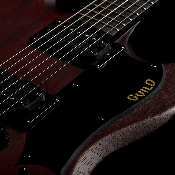Close-up of Polara Limited Night Edition Vintage Walnut pick guard with Guild logo thumb