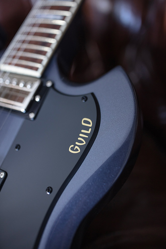 View of Polara Deluxe Canyon Dusk pickguard and Guild logo
