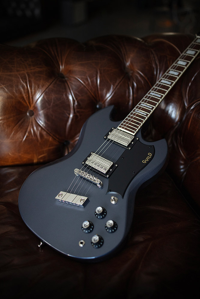 Polara Deluxe Canyon Dusk laying on leather couch