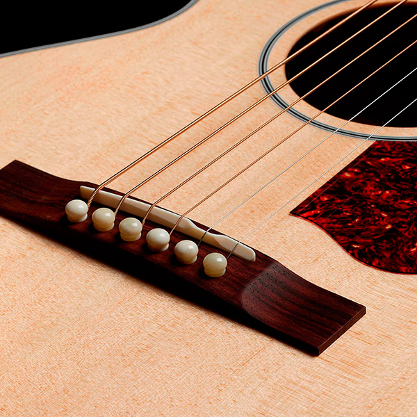 Close-up of the M-40 Standard Natural Indian rosewood bridge thumb