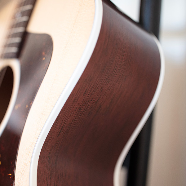 Close-up of F-40 Standard Natural side highlighting solid African mahogany thumb