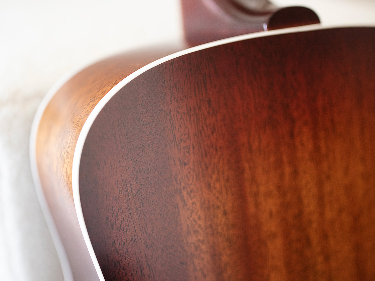 Close-up of the back of a D-40 Standard Pacific Sunset Burst highlighting the solid African mahogany