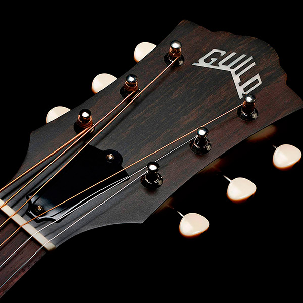 Close-up of front of the M-40 Standard Pacific Sunset Burst headstock with Guild Peak logo thumb