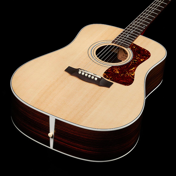 Top down view of D-50 Standard Natural body highlighting solid Sitka spruce top thumb