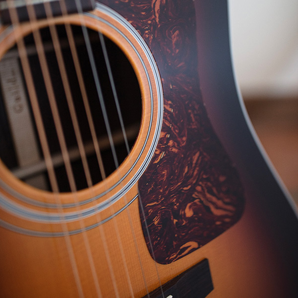 Close-up of D-50 Standard Antique Burst soundhole and pickguard thumb