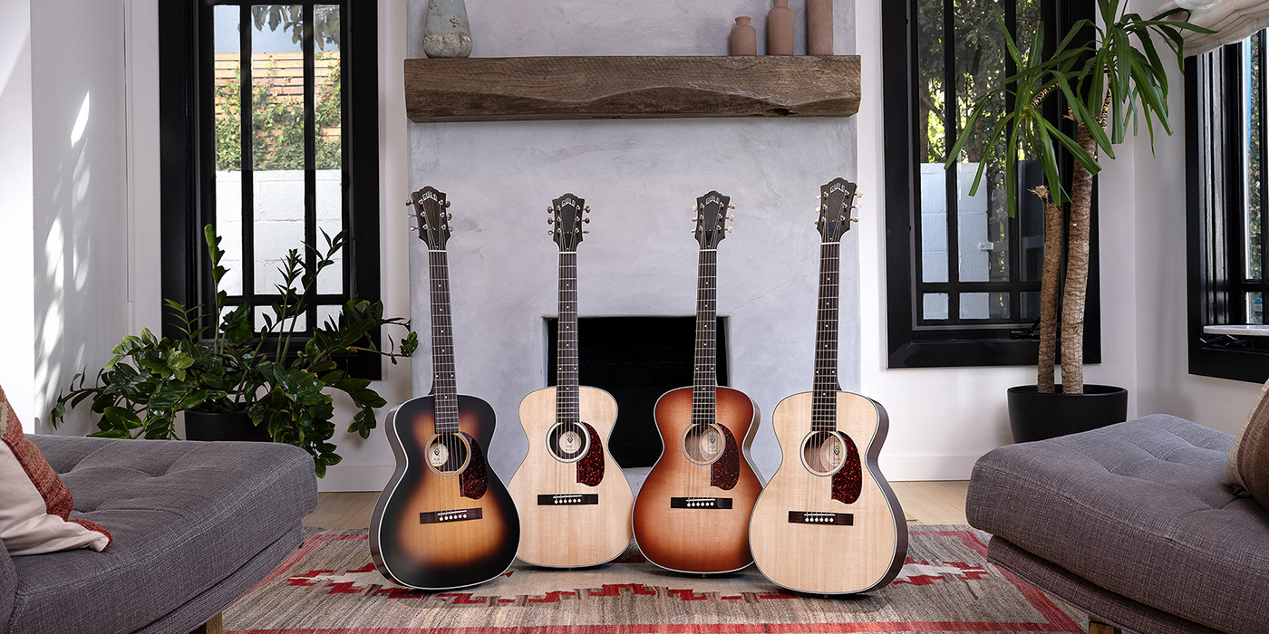 The M-40 and M-50 series acoustic guitars lined up in a cozy living room