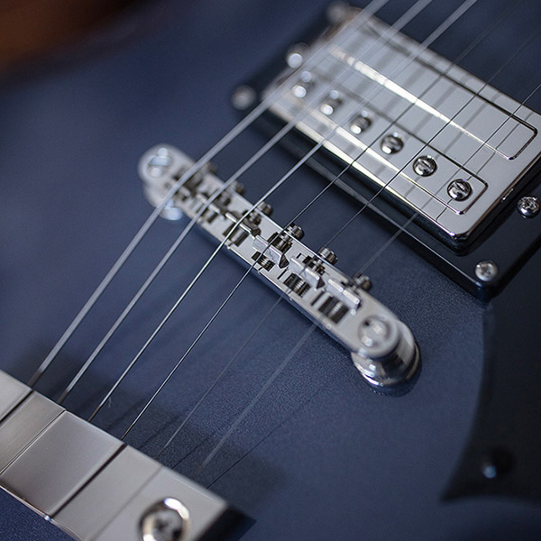 Close-up of Polara Deluxe Canyon Dusk bridge and pickup thumb