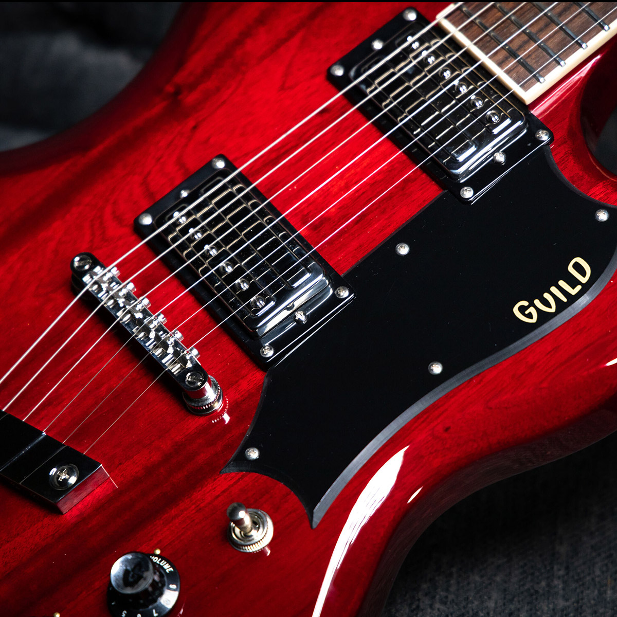 Close-up of Polara Deluxe Cherry Red body showing pickguard and pickups