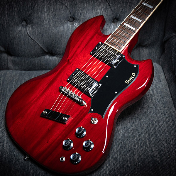 Polara Deluxe Cherry Red laying on a gray couch thumb