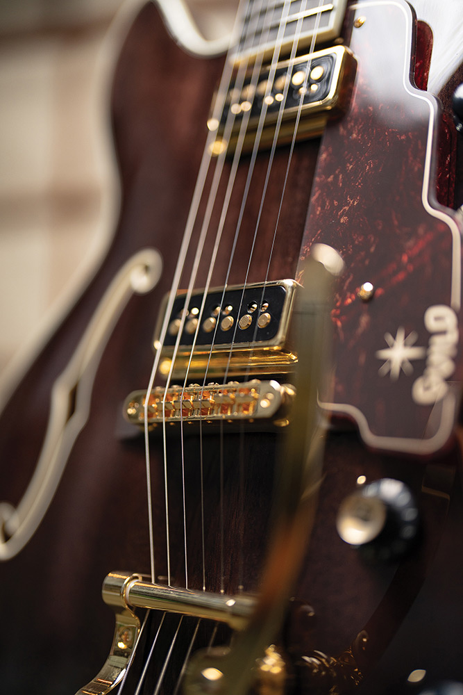 Close-up of a DeArmond Dynasonic pickup and tortoise pickguard on a Starfire Custom DC GVT GH, showing the printed Guild logo.
