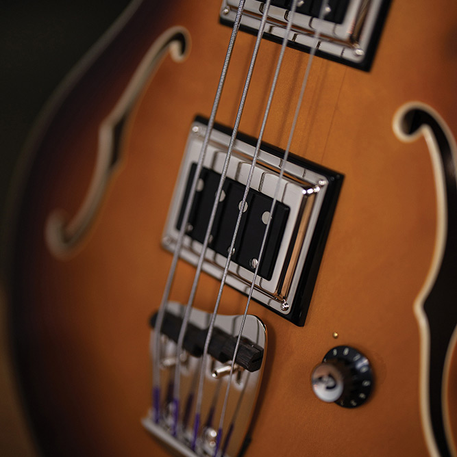 Close-up of a BS-1 BiSonic pickup and control knob on a Starfire Deluxe Bass Sweet Tea, showing the F-hole and maple top.
