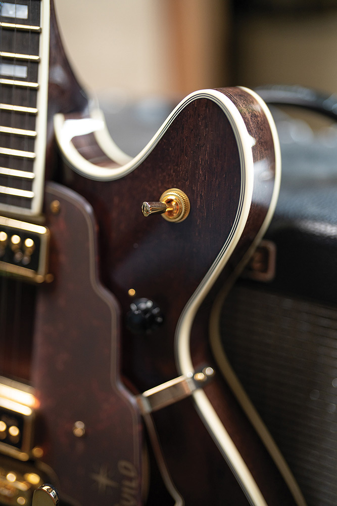 Close-up of the cutaway body edge on a Starfire Custom DC GVT GH, showing the gold output jack plate and ivory binding.