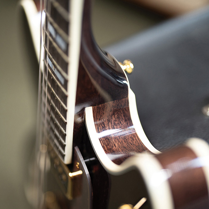 Close-up of the neck meeting the body on a Starfire Custom DC GVT GH, showing the bound ebony fingerboard and a mother-of-pearl V-block inlay.