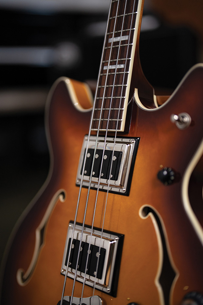 Close-up of the neck meeting the body on a Starfire Deluxe Bass Sweet Tea, showing the BS-1 BiSonic pickups and rosewood fingerboard with block inlays.