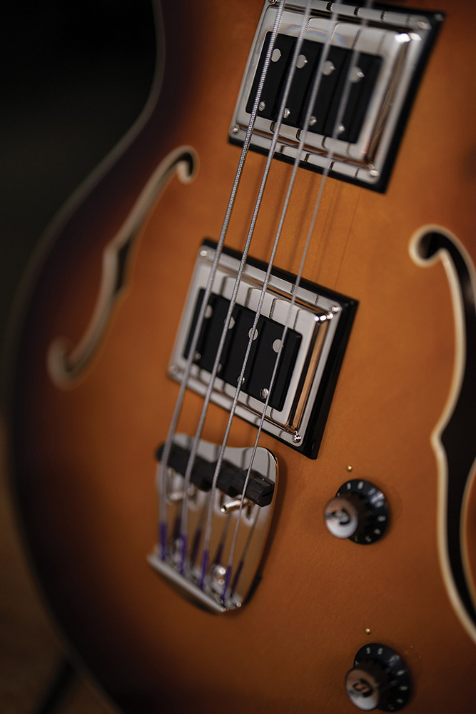 Close-up of a BS-1 BiSonic pickup and control knob on a Starfire Deluxe Bass Sweet Tea, showing the F-hole and maple top.