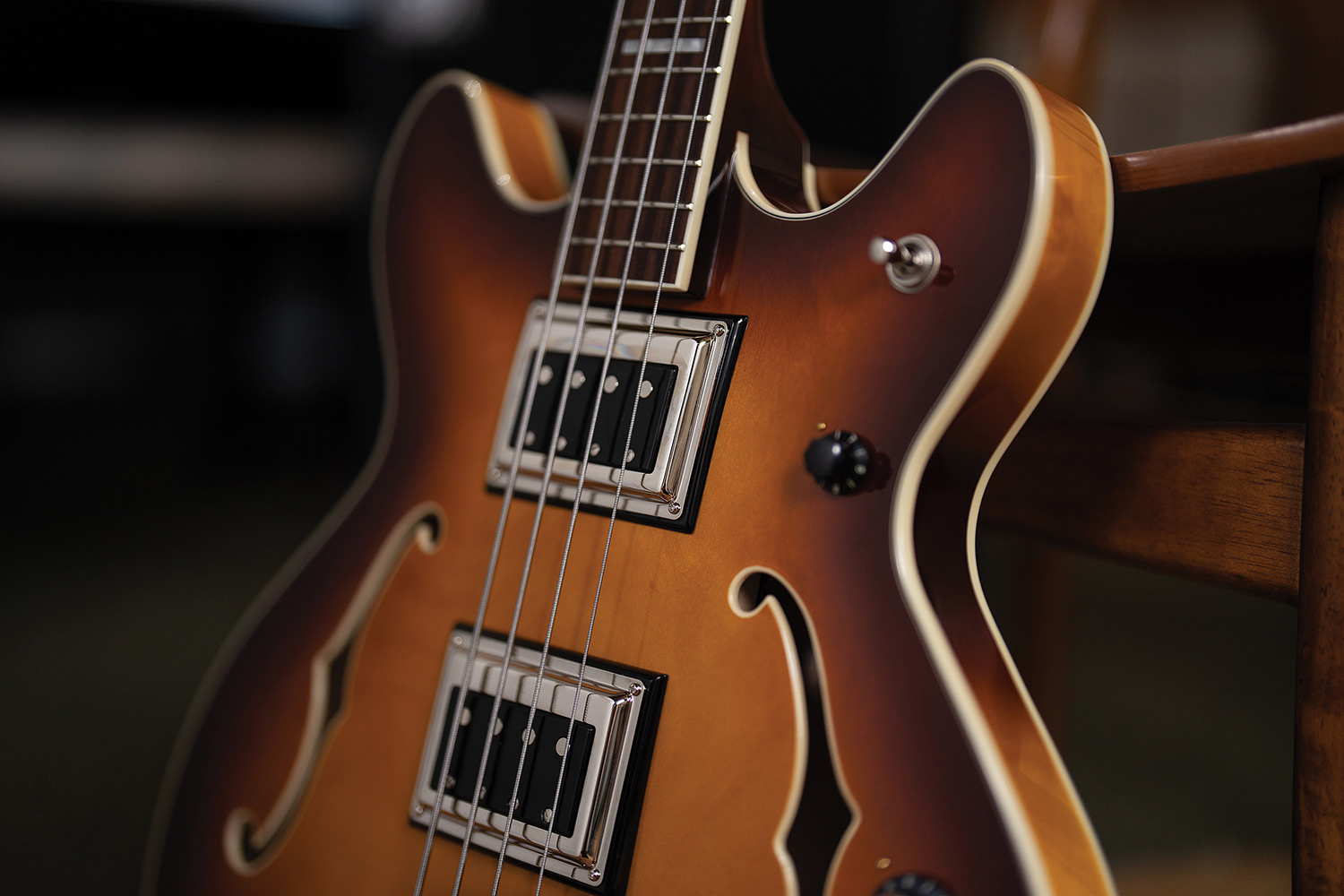 Close-up of both BS-1 BiSonic pickups and control knobs on a Starfire Deluxe Bass Sweet Tea, showing the F-hole and body binding.
