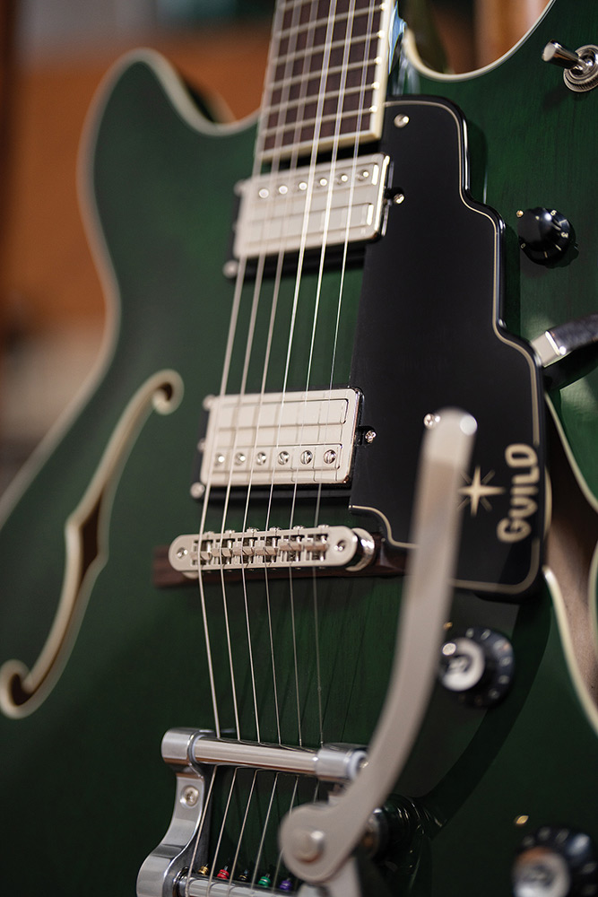 Close-up of a Starfire Deluxe DC GVT Emerald Green, showing both HB-2+ pickups, pickguard, and the Guild Vibrato tailpiece arm.