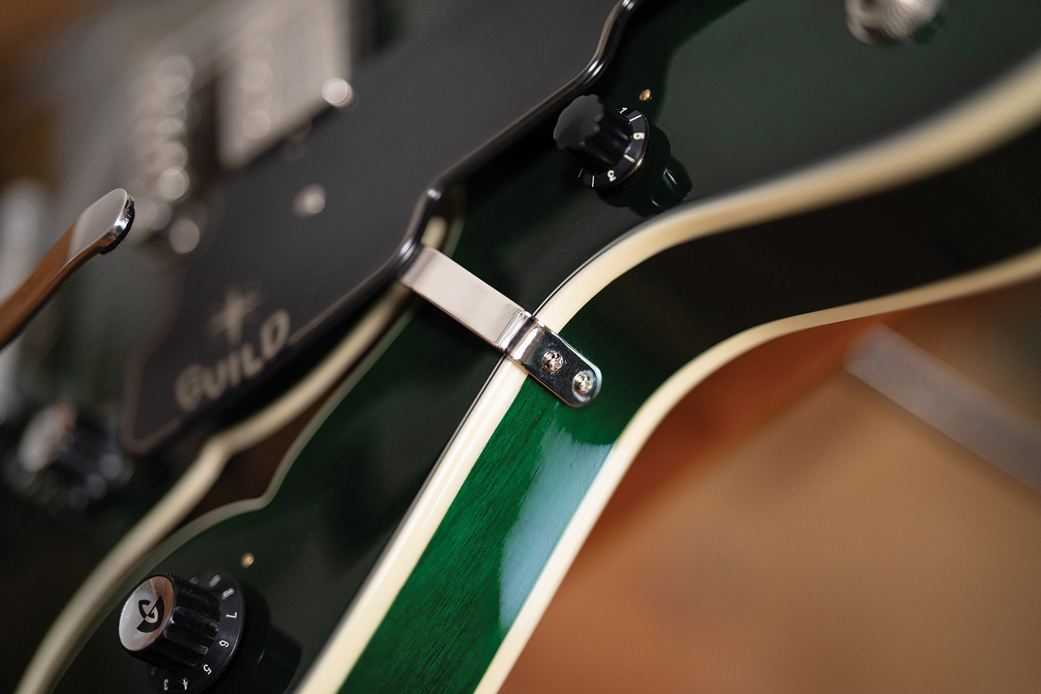 Close-up of a Starfire Deluxe DC GVT Emerald Green, showing the pickguard and ivory body binding.