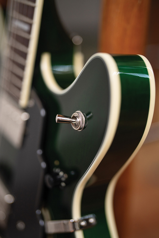 Close-up of the body edge and pickup selector switch on a Starfire Deluxe DC GVT Emerald Green, showing the ivory binding and Emerald Green finish.