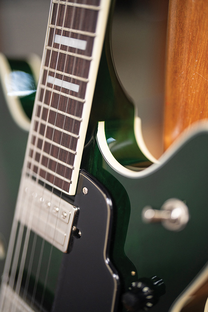 Close-up of the fingerboard and a pickup on a Starfire Deluxe DC GVT Emerald Green, showing the cutaway and ivory binding.