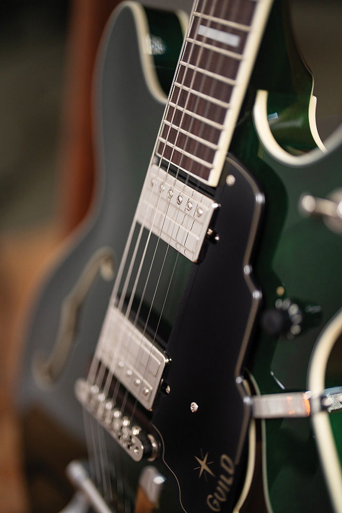 Close-up of the fingerboard and a pickup on a Starfire Deluxe DC GVT Emerald Green, showing the block inlays and F-hole.