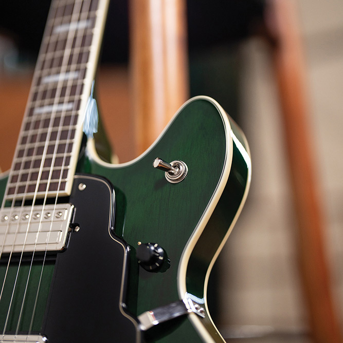 Close-up of the neck and cutaway on a Starfire Deluxe DC GVT Emerald Green, showing the pickup selector switch and pickguard.