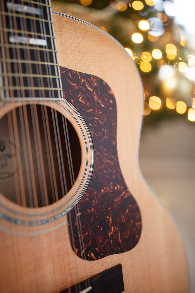 Close up of Guild F-512 Maple Blonde soundhole and pickguard