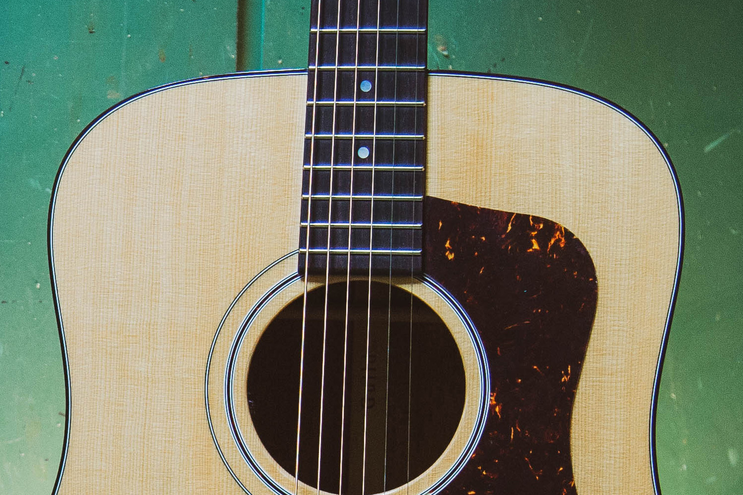 Close-up of F-40 acoustic guitar's neck and body, featuring Natural wooden finish and sound hole.