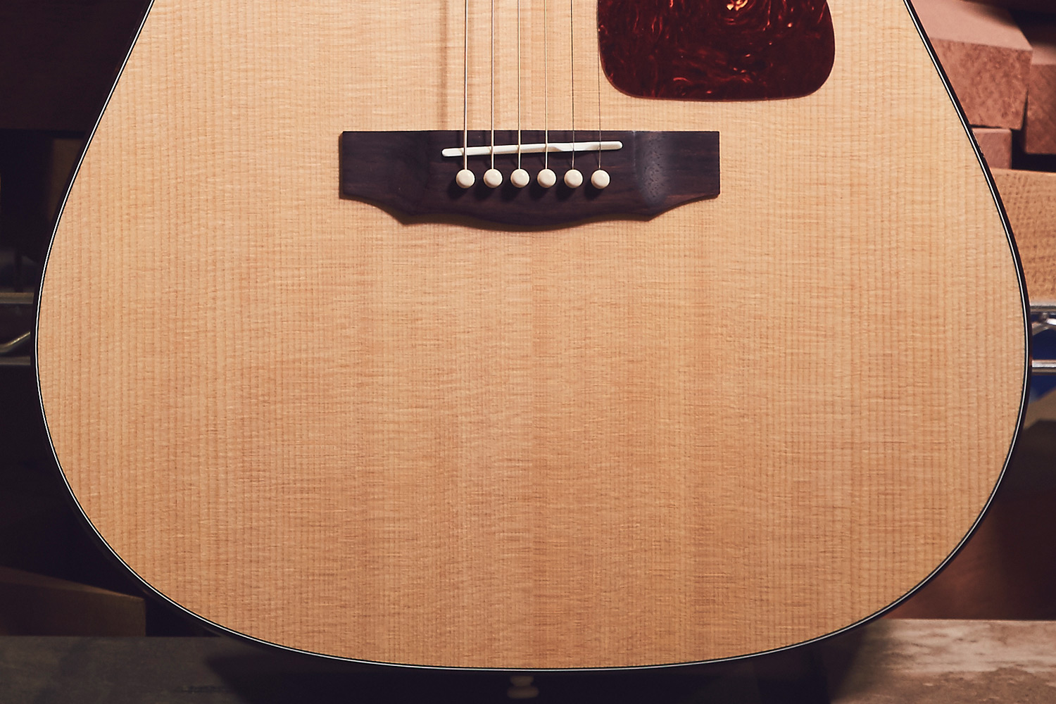 Close-up of D-40 acoustic guitar's body, showcasing the wood grain, bridge, and pickguard.
