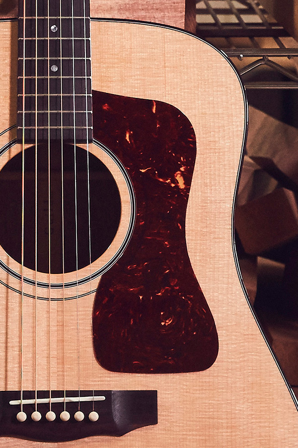 Close-up of D-40 acoustic guitar featuring a solid sitka spruce wooden body.