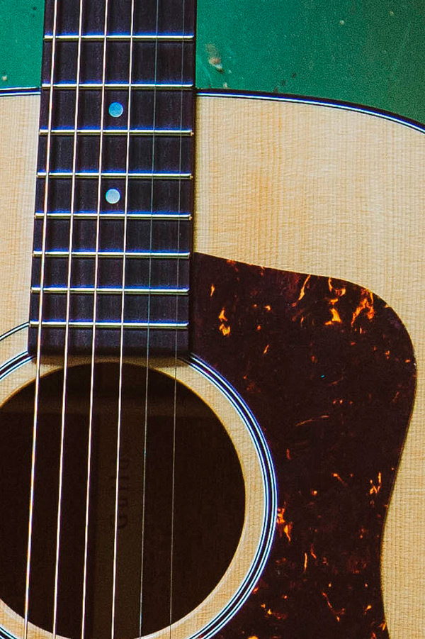 Close-up of F-40 acoustic guitar's neck and body, featuring Natural wooden finish and sound hole.